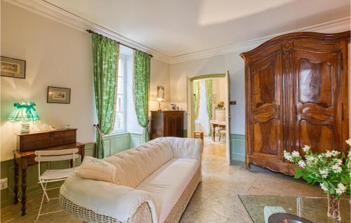 a living room with a couch and a table at Cozy Apartment In Saint Jean Du Bruel in Saint-Jean-du-Bruel