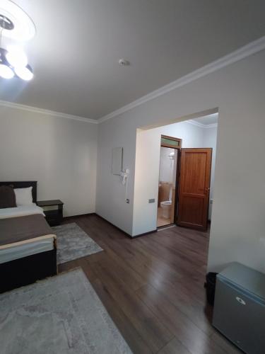 an empty room with a bed and a bathroom at Qusar Qala Hotel in Qusar