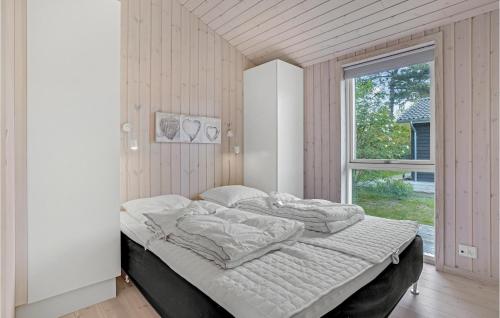 ニュークビン・シェランにあるAwesome Home In Nykbing Sj With 2 Bedrooms And Wifiの窓付きの客室の大型ベッド1台分です。