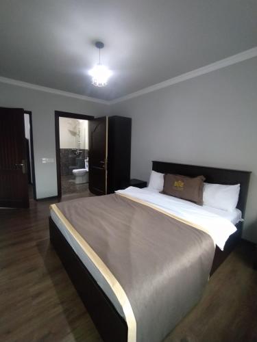 a bedroom with a large bed in a room at Qusar Qala Hotel in Qusar