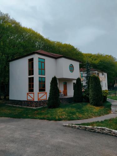 a small white house with a grass hill at Qusar Qala Hotel in Qusar