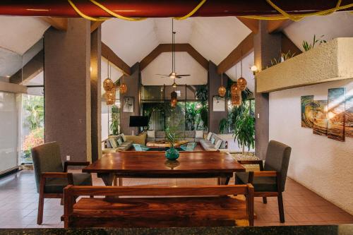 a dining room with a wooden table and chairs at Casa Sirena in Ixtapa