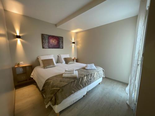a bedroom with a large bed in a room at La Maison de Jade & Spa in La Roche-de-Glun