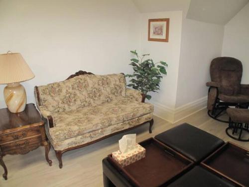 a living room with a couch and a table at Wolseley the heart of the city ! in Winnipeg