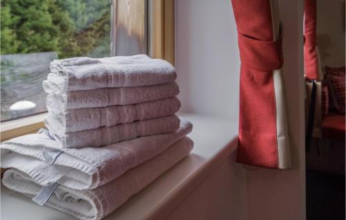 a stack of towels sitting on a window sill at 1 Bedroom Lovely Apartment In Unterweg 