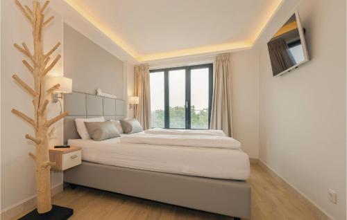 a white bedroom with a bed and a window at Penthouse Cloud in Binz