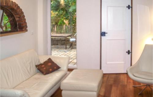 a living room with a white couch and a door at Awesome Home In Btzow With Wifi in Bützow