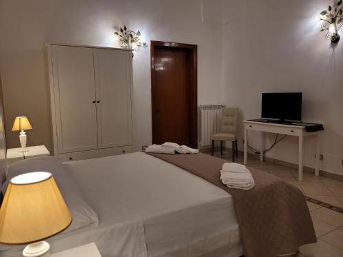 a bedroom with a bed and a desk with a computer at Casal Sant'Angelo in Copertino
