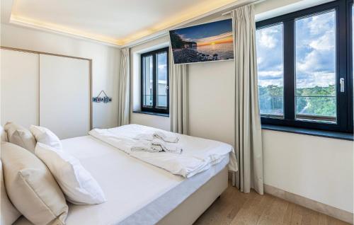 a bedroom with a bed and two windows at Skysuite in Binz