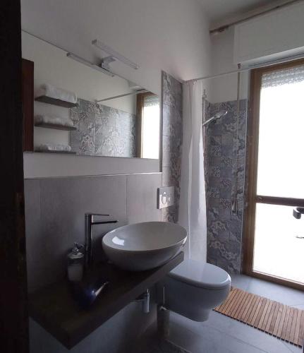 a bathroom with a sink and a toilet at Casa Minù in Viareggio