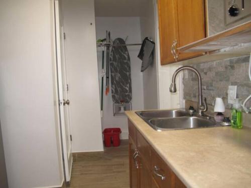 a kitchen with a sink and a counter top at Wolseley the heart of the city ! in Winnipeg