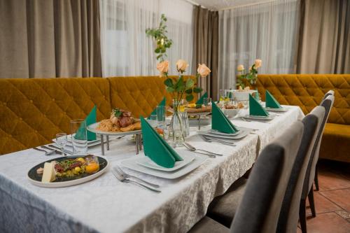 a long table with plates of food on it at Zajazd Błonie in Błonie