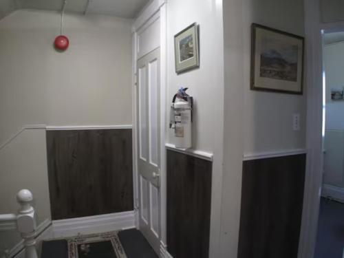 a hallway with a door to a room at Wolseley the heart of the city ! in Winnipeg