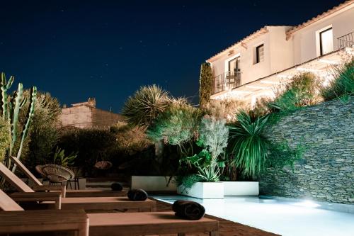 a courtyard with chairs and a building at night at Boutique Hotel Villa Gala by Fimedhotels in Cadaqués