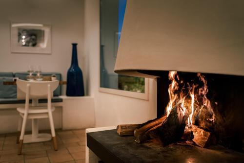 a fireplace in a living room with a stove at Boutique Hotel Villa Gala by Fimedhotels in Cadaqués