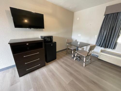 a small room with a table and a television at Villa Inn Anaheim in Anaheim