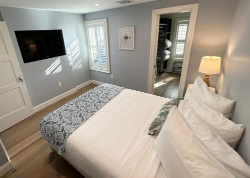 a bedroom with a large bed and a television at Beautifully Renovated 2 Bed 2 Bath Private Home in Newport