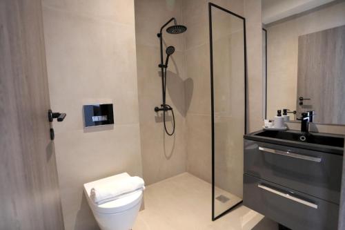 y baño con ducha, aseo y lavamanos. en Junior Unicorn Suite, en Atenas