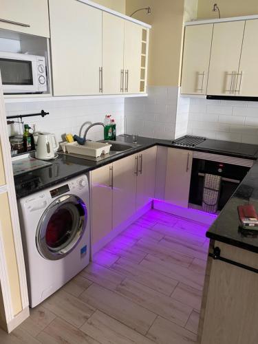 a kitchen with a purple light in the floor at Casa MaGia in Playa de las Americas