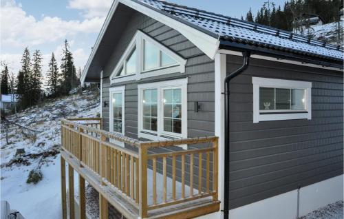 a tiny house with a deck in the snow at Stunning Home In Slen With 3 Bedrooms in Sälen