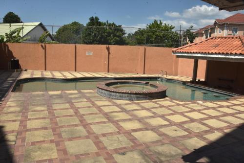 a swimming pool with a tire in the middle at Embassy Deluxe apartment in Kingston