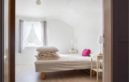 a white bedroom with a bed and a window at Awesome Home In Hauge I Dalane With 5 Bedrooms And Wifi in Sogndalsstrand