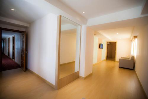 a hallway with a large mirror in a room at Golden City Rayong Hotel in Rayong