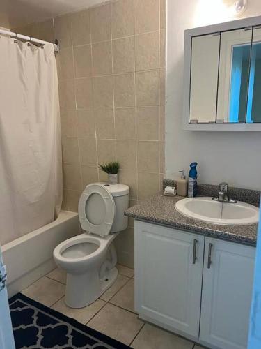 a bathroom with a toilet and a sink at Cozy and lovely 2 bed apartment in Toronto