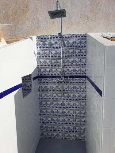 a bathroom with blue and white tiles on a wall at Casa Marlo, Spacious House in the Lively Centre of Cómpeta in Cómpeta