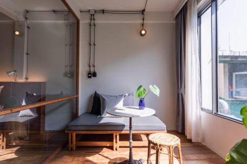 a room with a table and a chair and a window at GalileOasis Boutique Hotel in Bangkok