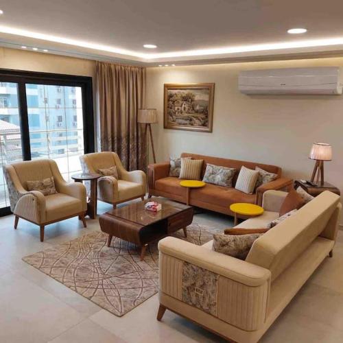 a large living room with couches and chairs at شقة فاخرة تشطيب فندقي حي المهندسين بالقاهرة in Cairo