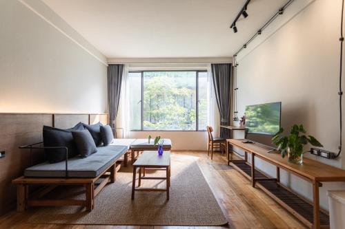 a living room with a couch and a table at GalileOasis Boutique Hotel in Bangkok