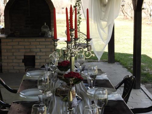 a table with red candles and wine glasses on it at Vikendica Budžak 51 - Apatin in Apatin