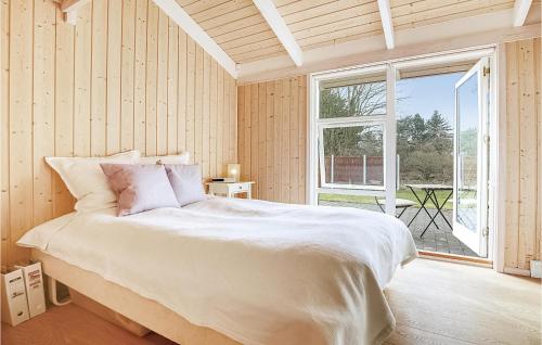 um quarto com uma cama grande e uma janela grande em Amazing Home In Sjllands Odde With Kitchen em Tjørneholm