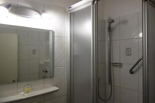 a bathroom with a shower with a glass door at Hotel Lex in Hagen