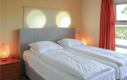 a bedroom with a large white bed with two pillows at Lisdodde in Workum