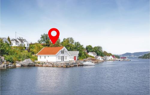a house on a island in the water with a red marker at Amazing Home In Skjoldastraumen in Skjoldastraumen
