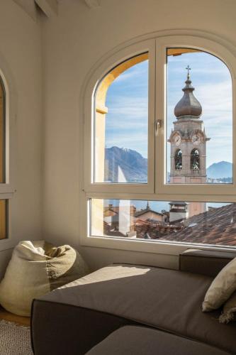 a bedroom with a window with a view of a building at Torre di Castelli - Menaggio by LoveComo in Menaggio