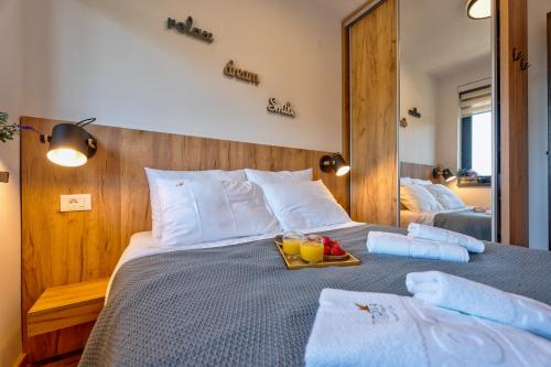 a bedroom with a bed with a tray of fruit on it at Vardar 64 (Titova Vila) in Zlatibor