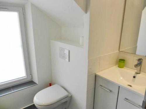 a white bathroom with a toilet and a sink at Day's Inn Cannes in Cannes