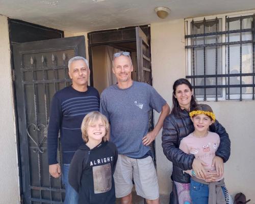 a family posing for a picture in front of a door at شقة سيلا in Irbid