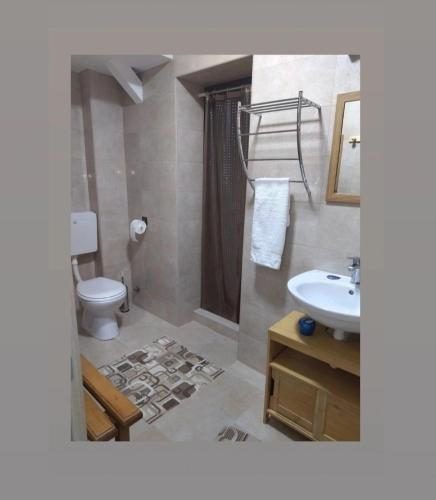 a bathroom with a toilet and a sink at Apartmani S - DSN in Kraljevo