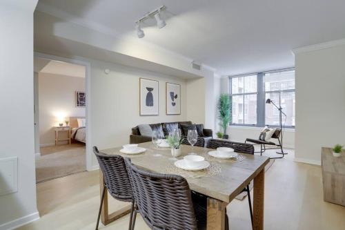 a dining room and living room with a table and chairs at Spacious 2 BR Apartment At Pentagon City in Arlington