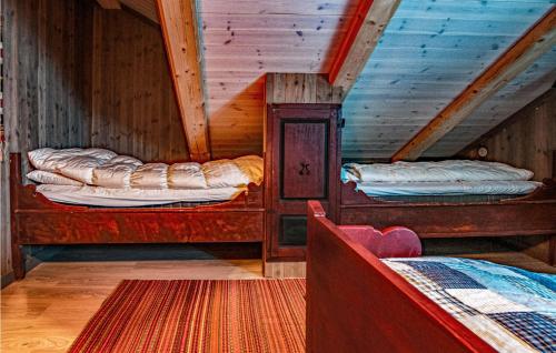 two bunk beds in a room with wooden ceilings at Nice Home In Nybergsund With 4 Bedrooms in Nybergsund