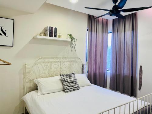 a bedroom with a white bed with a ceiling fan at Selayang 18 Residences (100mbps Wifi & Netflix) in Batu Caves