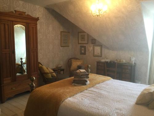 a bedroom with a bed with a teddy bear on it at Nether Dallachy Farmhouse in Banff