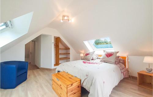 a bedroom with a white bed and a blue chair at Lovely Home In Ledinghem With Kitchen in Seninghem