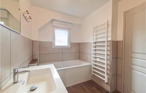 a bathroom with a sink and a bath tub at Lovely Home In Ledinghem With Kitchen in Seninghem
