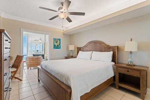 a bedroom with a bed and a ceiling fan at Summer House 1501B in Orange Beach