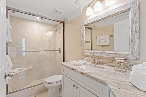 a bathroom with a shower and a sink and a toilet at Summer House 1501B in Orange Beach